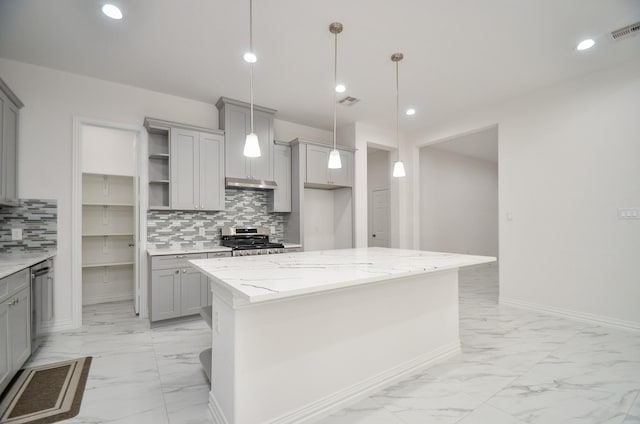 kitchen featuring a center island, decorative backsplash, gray cabinets, decorative light fixtures, and stainless steel appliances