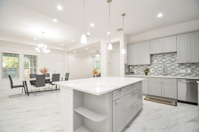 kitchen featuring dishwasher, a center island, decorative light fixtures, gray cabinets, and ceiling fan with notable chandelier