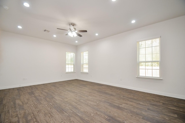 empty room with ceiling fan and dark wood-type flooring