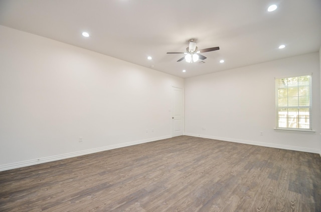 spare room with ceiling fan and dark hardwood / wood-style flooring