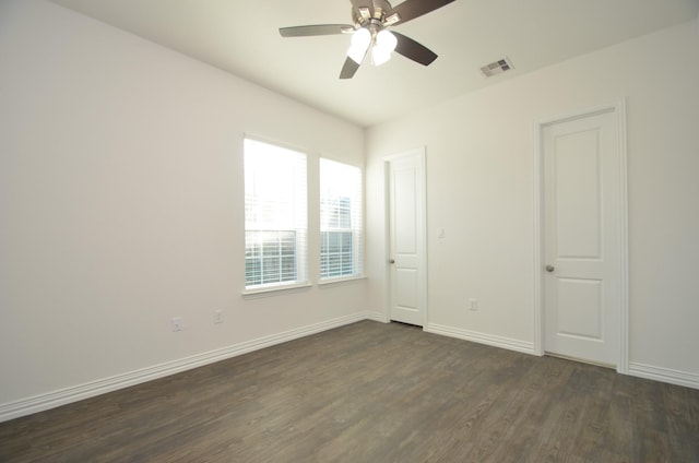 empty room with ceiling fan and dark wood-type flooring