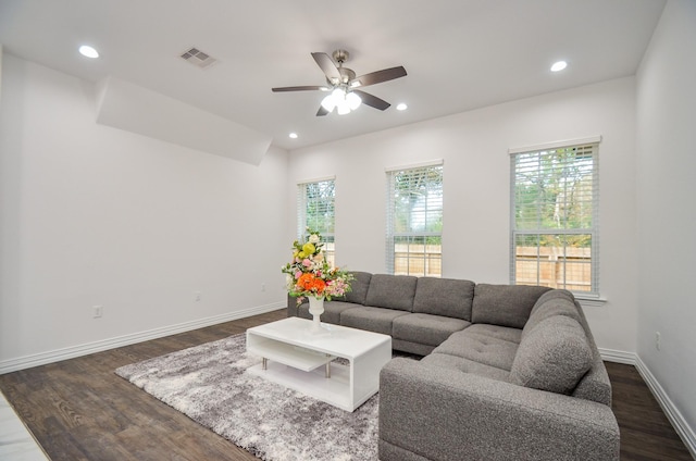 living room with dark hardwood / wood-style floors and ceiling fan