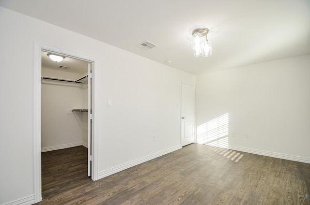 interior space with dark hardwood / wood-style floors, a spacious closet, and a closet