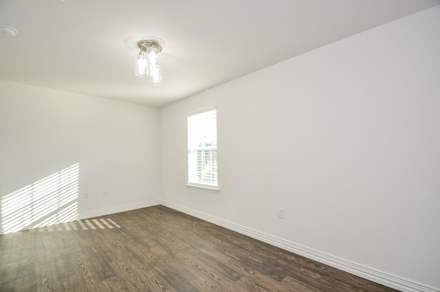 empty room featuring dark wood-type flooring