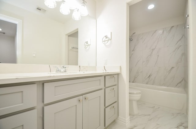 full bathroom with tiled shower / bath combo, toilet, and vanity