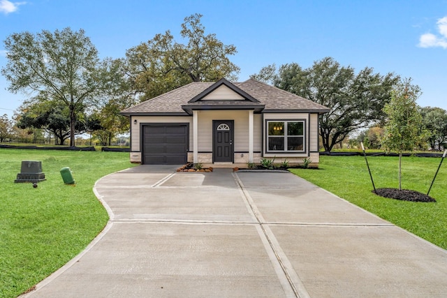 view of front of property featuring a front yard and a garage