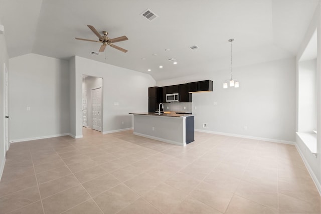 kitchen with sink, ceiling fan, light tile patterned floors, an island with sink, and decorative light fixtures