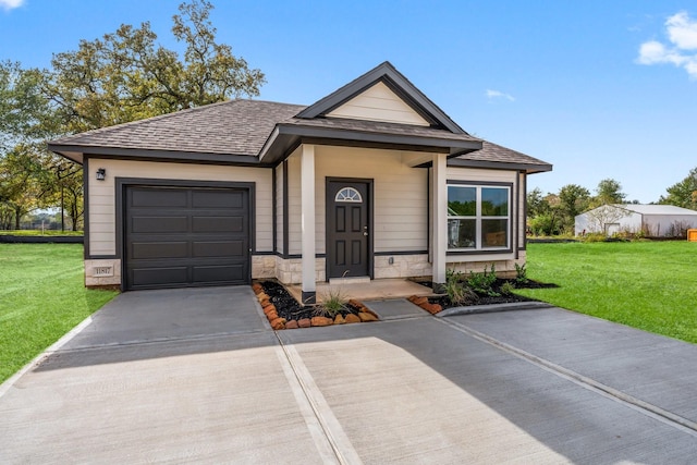 view of front of home with a front lawn and a garage