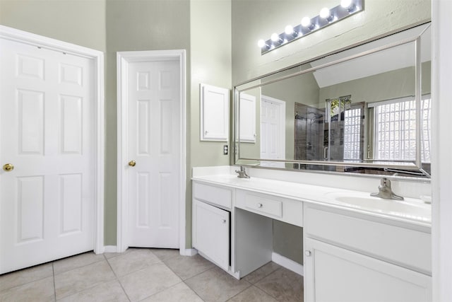 bathroom with tile patterned floors, vanity, and walk in shower