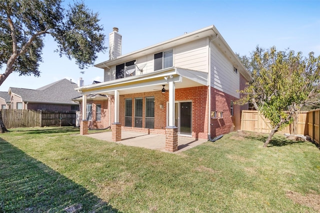 rear view of property featuring a lawn, a patio area, and ceiling fan