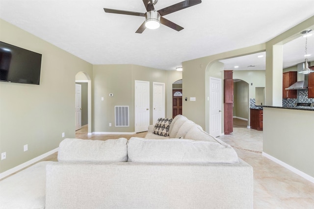 living room featuring ceiling fan and light tile patterned flooring