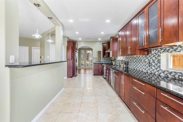 kitchen with pendant lighting, dishwasher, decorative backsplash, dark stone countertops, and plenty of natural light