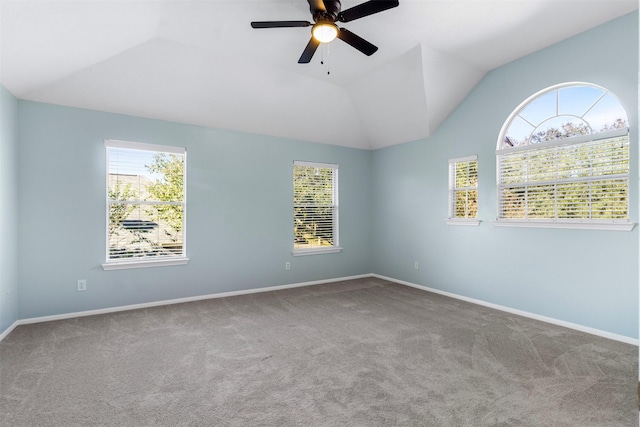 carpeted empty room with vaulted ceiling and ceiling fan