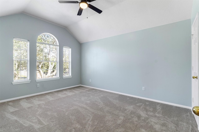 carpeted empty room featuring vaulted ceiling and ceiling fan