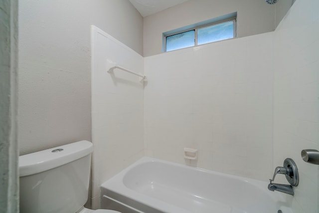 bathroom featuring toilet and shower / bathtub combination