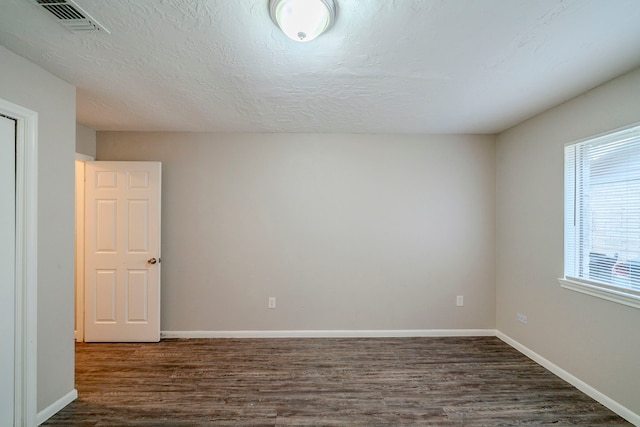 empty room featuring dark hardwood / wood-style floors