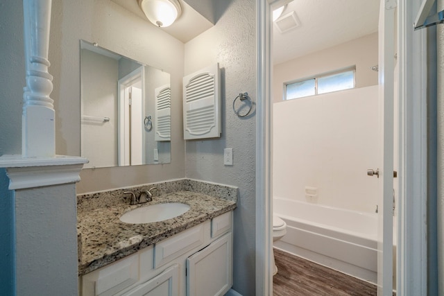 full bathroom with vanity, hardwood / wood-style flooring, toilet, and shower / bathtub combination