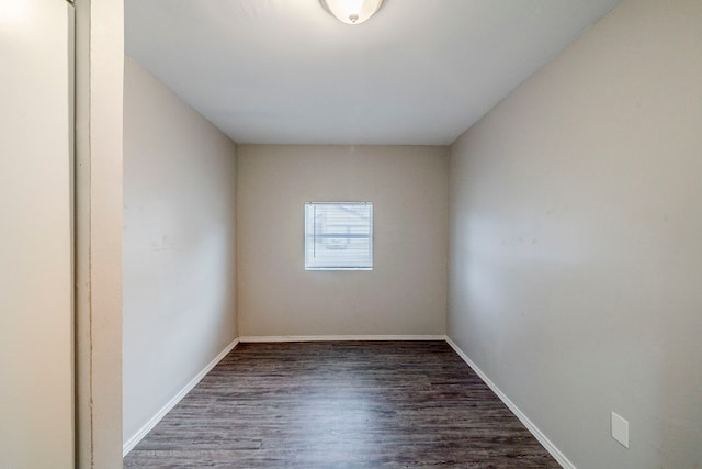 unfurnished room with dark hardwood / wood-style flooring