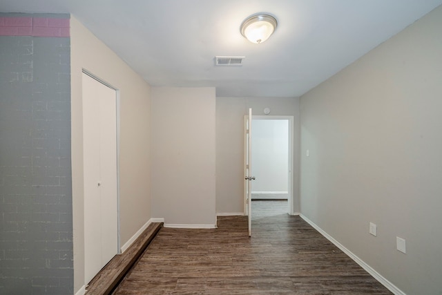 corridor featuring dark wood-type flooring