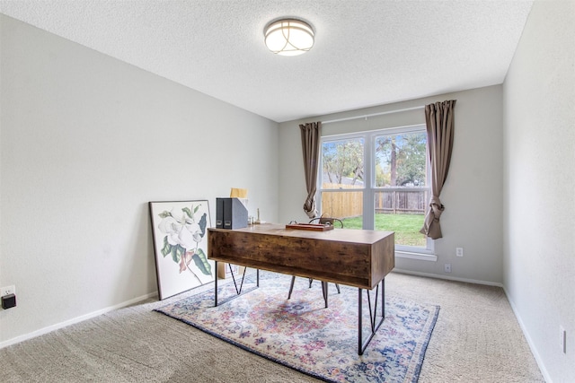 office area with a textured ceiling and carpet floors