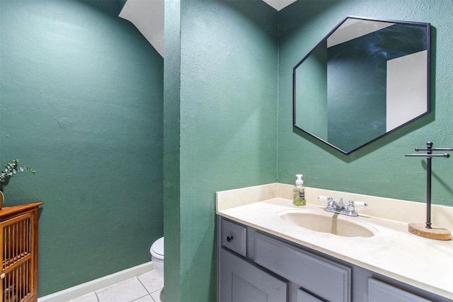 bathroom with tile patterned flooring, vanity, and toilet