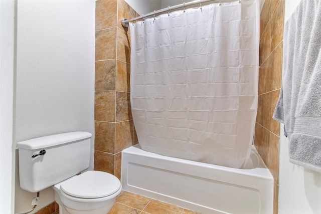 bathroom featuring tile patterned flooring, shower / tub combo with curtain, and toilet