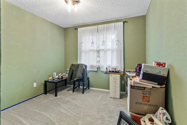 carpeted office space featuring a textured ceiling