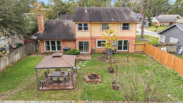 back of house featuring a gazebo and a yard