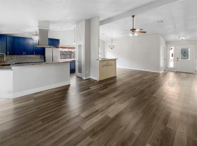 unfurnished living room featuring a textured ceiling, ceiling fan with notable chandelier, and dark wood-type flooring