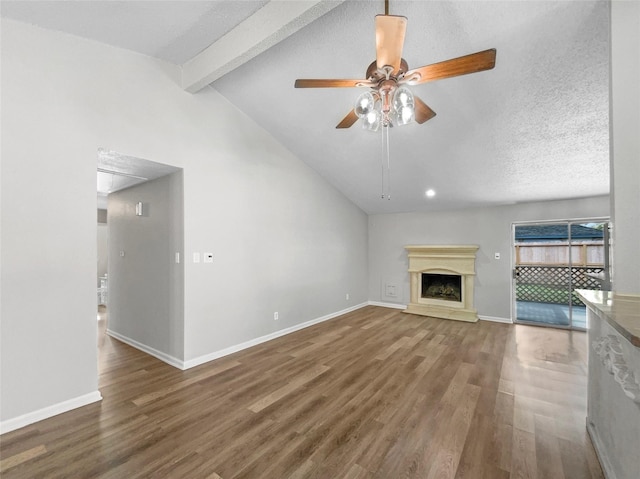 unfurnished living room featuring a textured ceiling, ceiling fan, high vaulted ceiling, beamed ceiling, and dark hardwood / wood-style floors