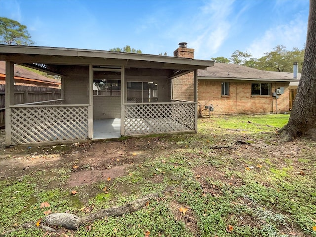 back of property with a sunroom