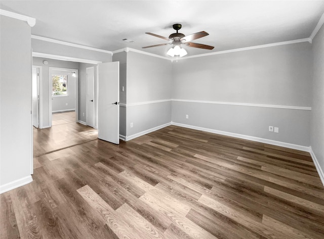 spare room with dark hardwood / wood-style flooring, ceiling fan, and crown molding