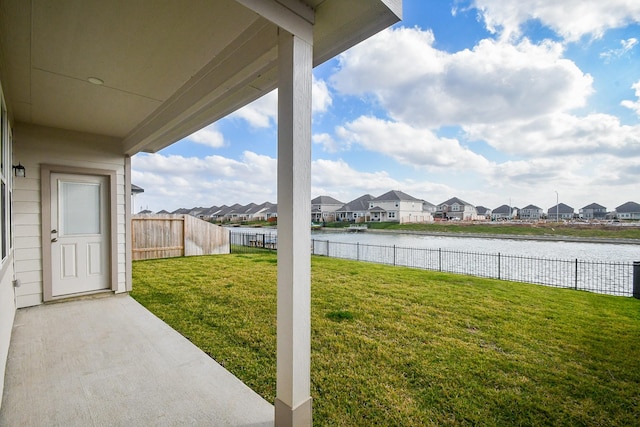 view of yard featuring a patio and a water view