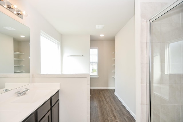 bathroom featuring hardwood / wood-style floors, vanity, and a shower with shower door