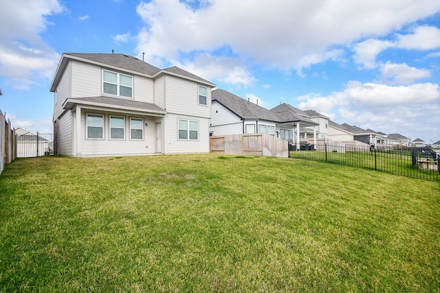 rear view of property with a lawn