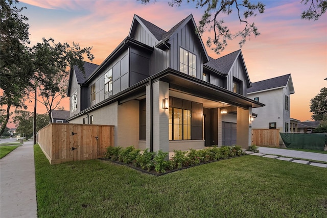 property exterior at dusk featuring a yard