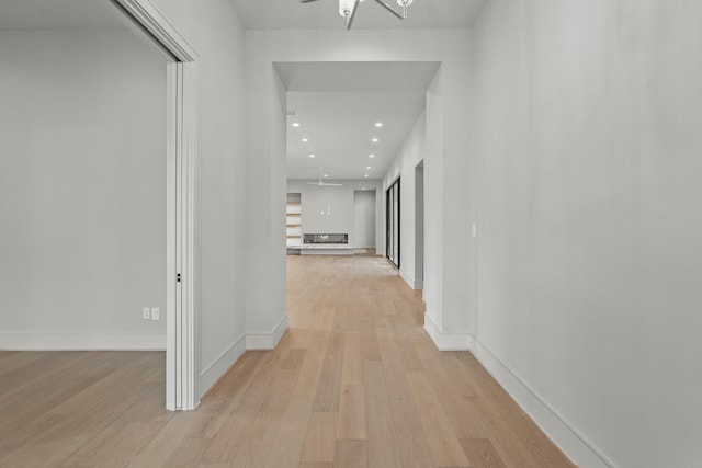 corridor with light hardwood / wood-style flooring