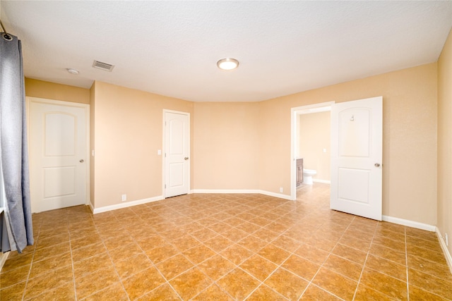 empty room with a textured ceiling