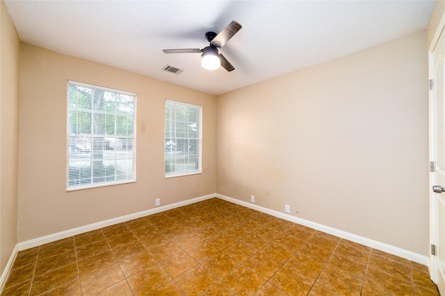 tiled empty room with ceiling fan