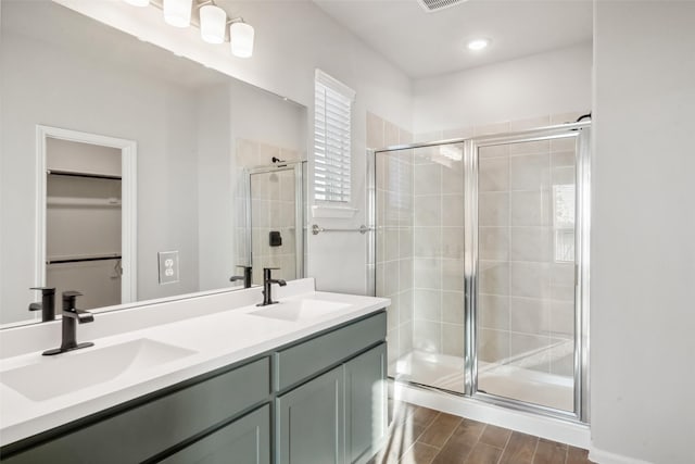 bathroom featuring vanity, an enclosed shower, and hardwood / wood-style flooring