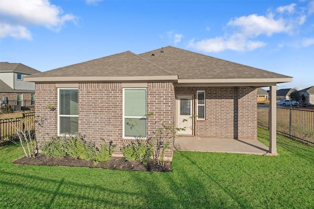 rear view of property with a patio area and a yard