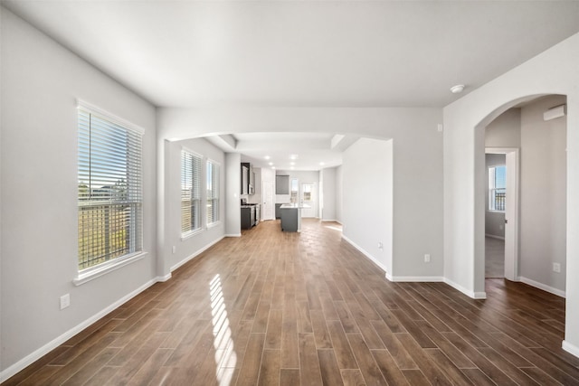 unfurnished living room with dark hardwood / wood-style flooring