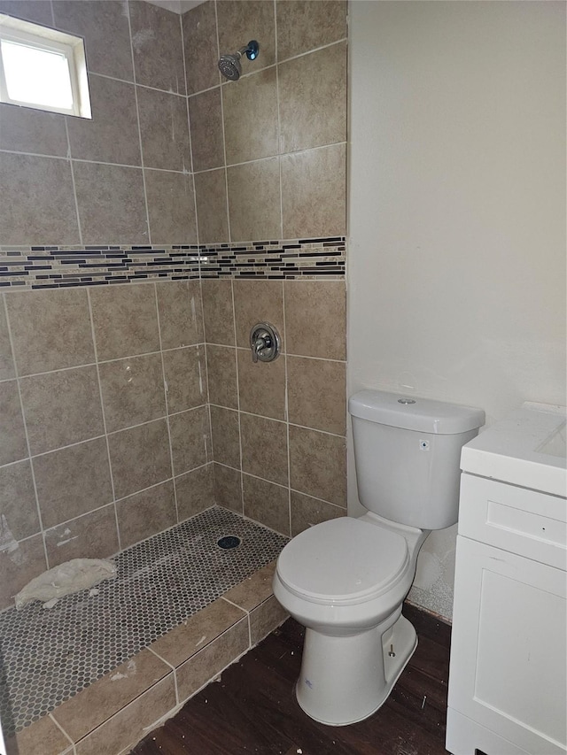 9736 Kerr St, Houston, TX 77029 - bathroom featuring wood finished floors, tiled shower, and vanity