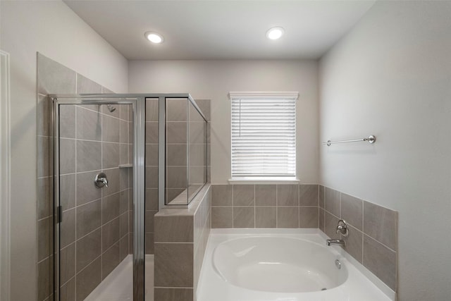 bathroom with shower with separate bathtub