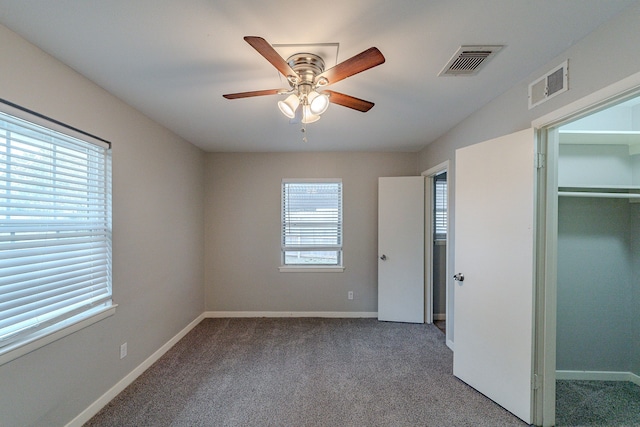 unfurnished bedroom with carpet, a closet, and ceiling fan