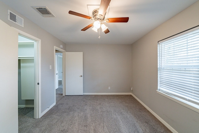 unfurnished room with carpet flooring and ceiling fan