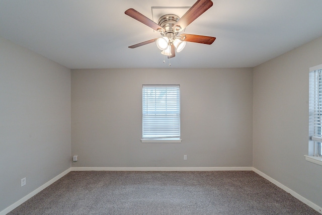 spare room featuring ceiling fan and carpet