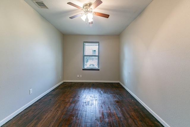 empty room featuring dark hardwood / wood-style flooring and ceiling fan