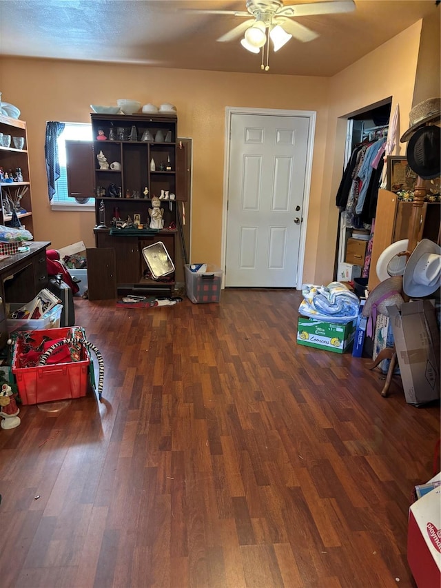 miscellaneous room featuring ceiling fan and dark hardwood / wood-style flooring