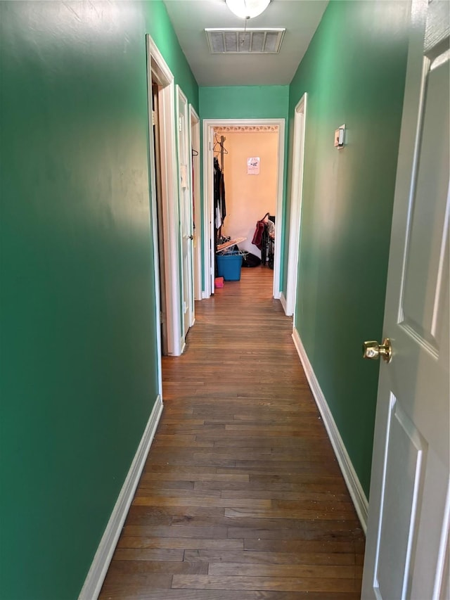 corridor featuring dark wood-type flooring